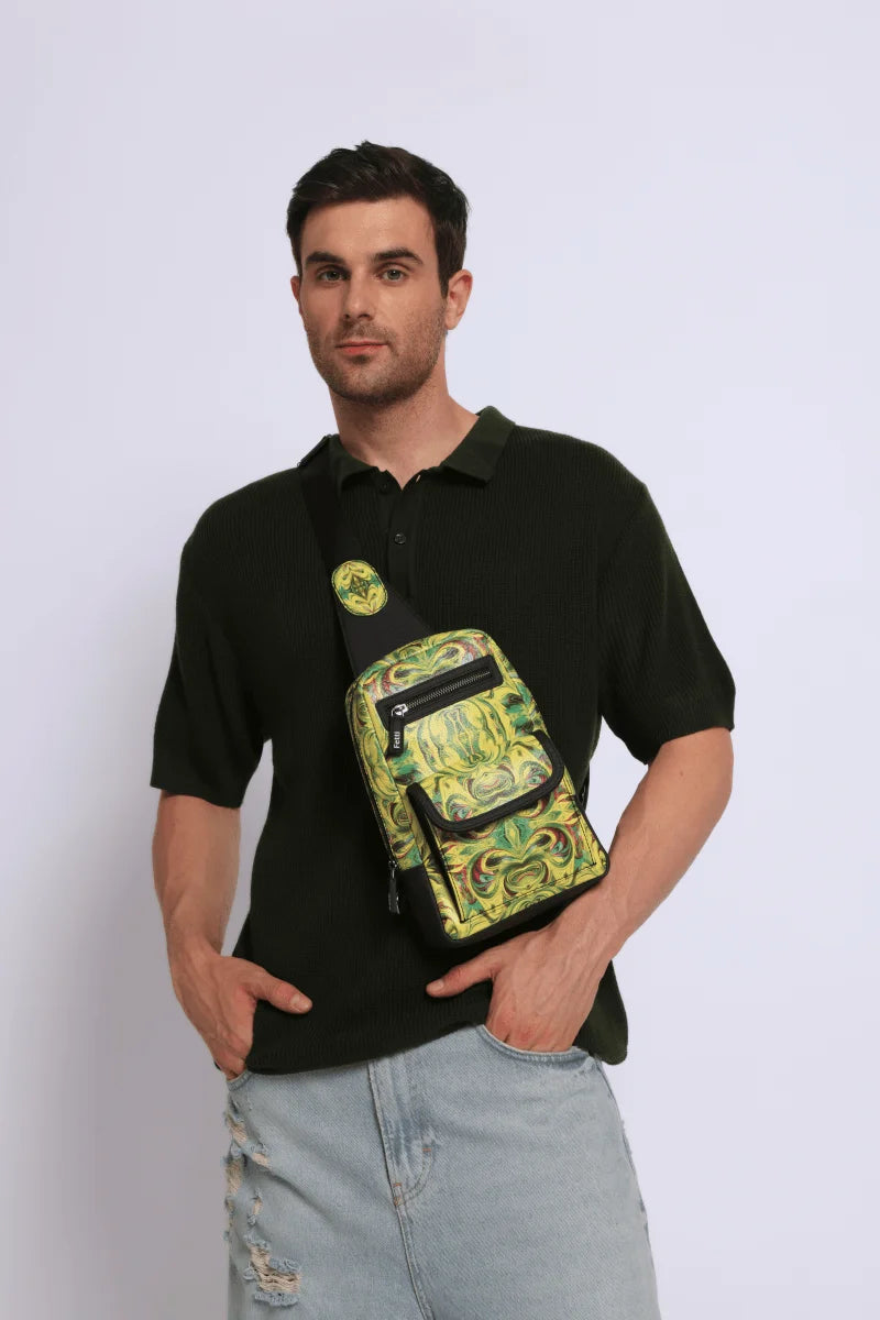 Man wearing a dark polo shirt with a Kosmic Immersion sling bag helios over his shoulder on a white background