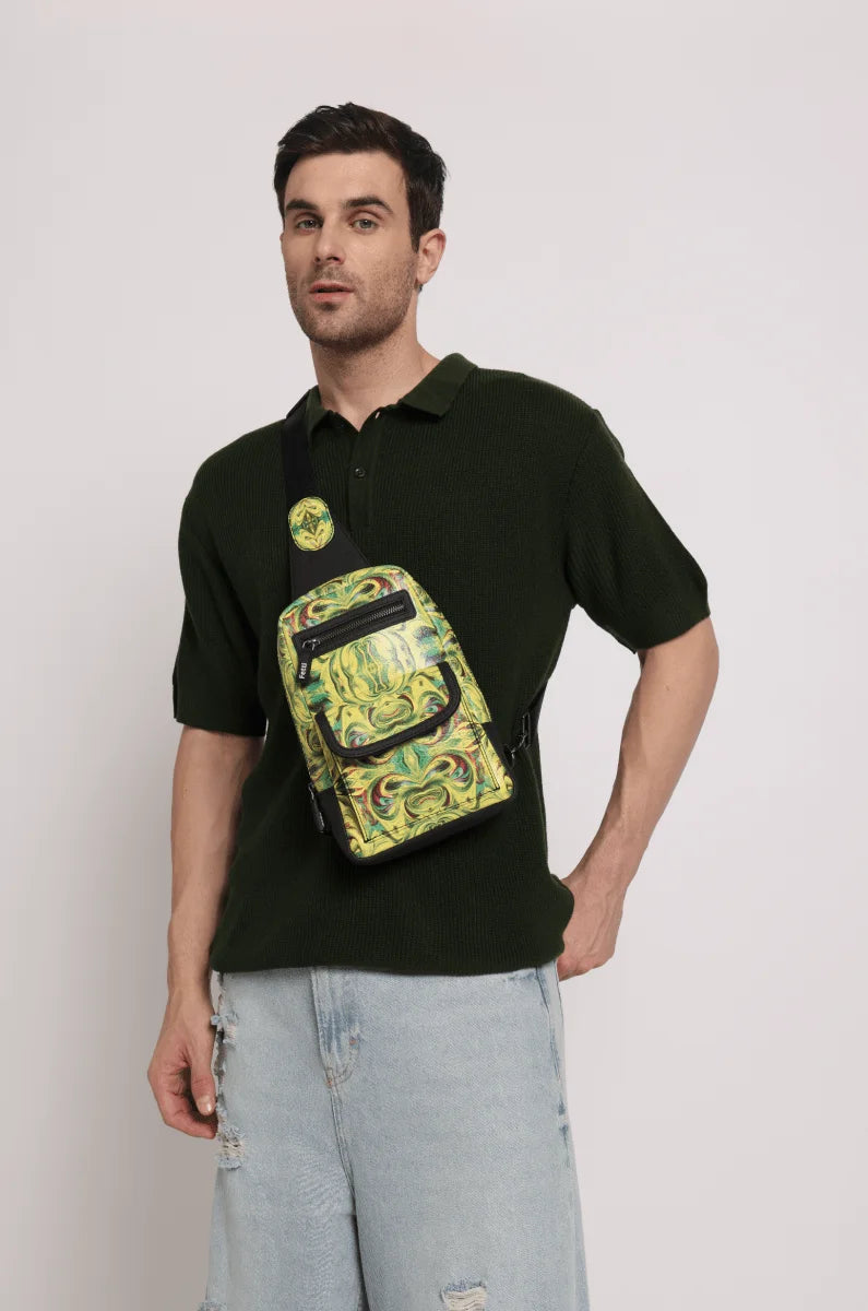 Man wearing a dark polo shirt along with men’s crossbody sling bag over his shoulder against a white background