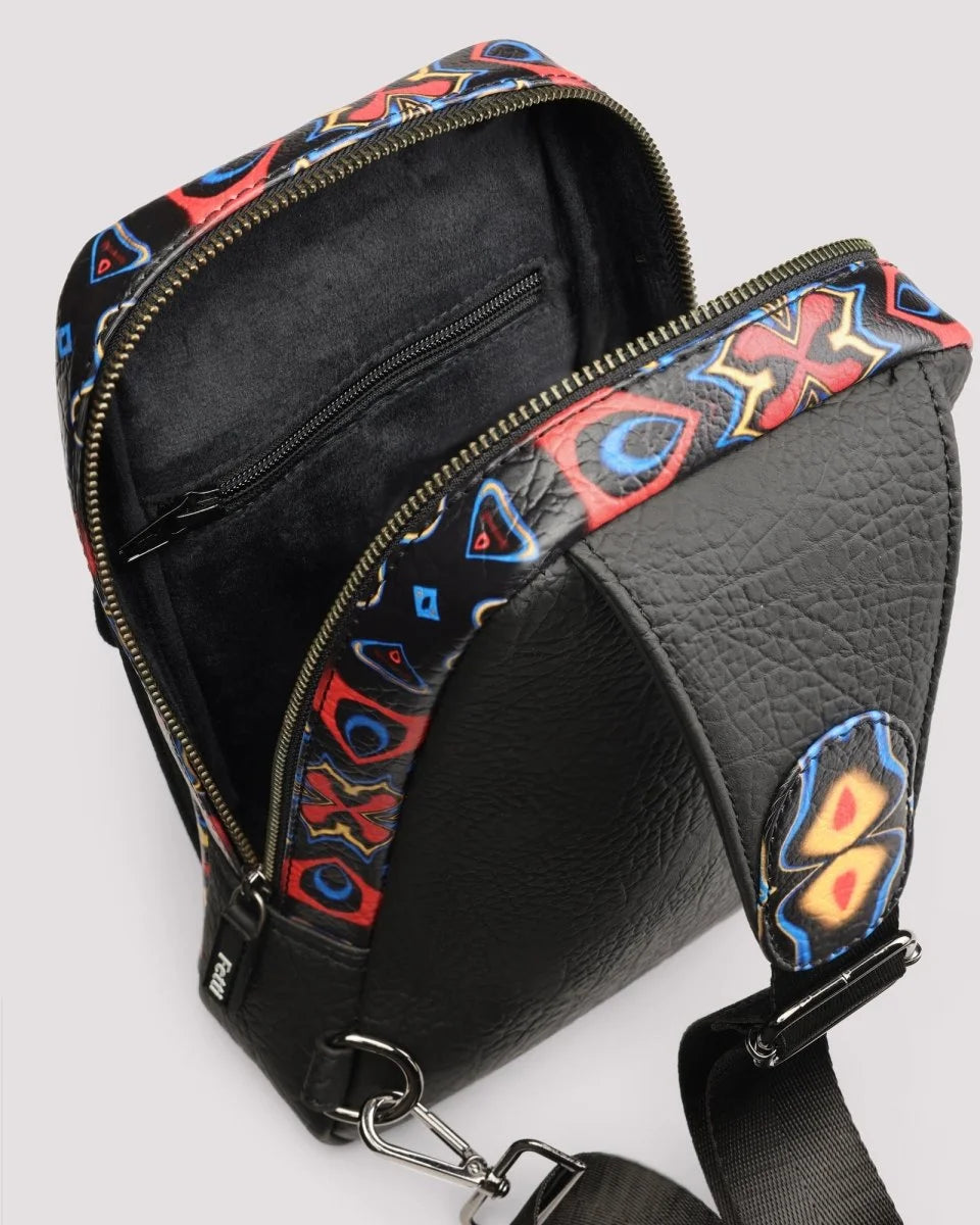 Close-up of premium zipper closure on sling bag on a light gray background