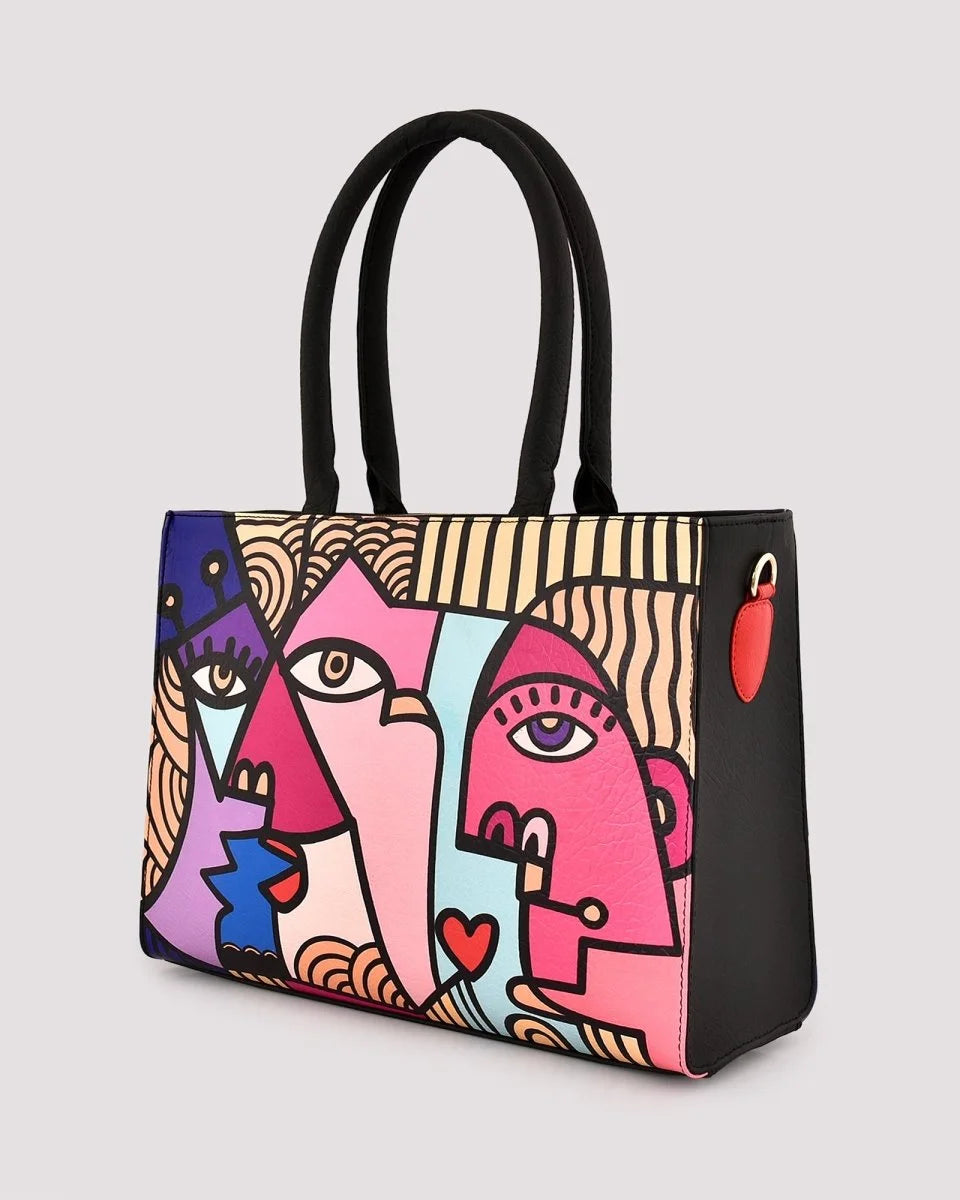 Pink graphic tote bag with playful face print design on a light gray background