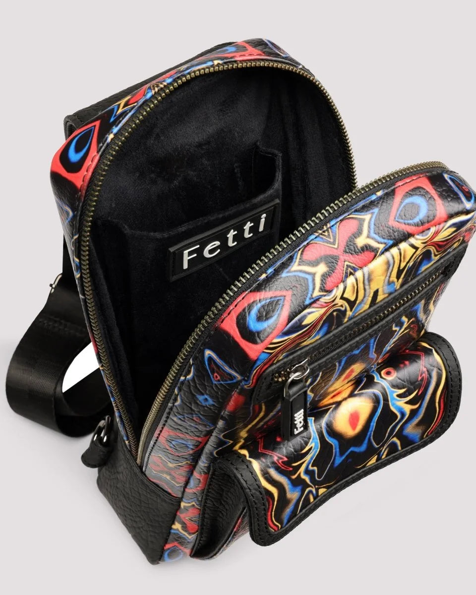 Organized interior compartments of men’s sling bag with 'Fetti' branding on a light gray background