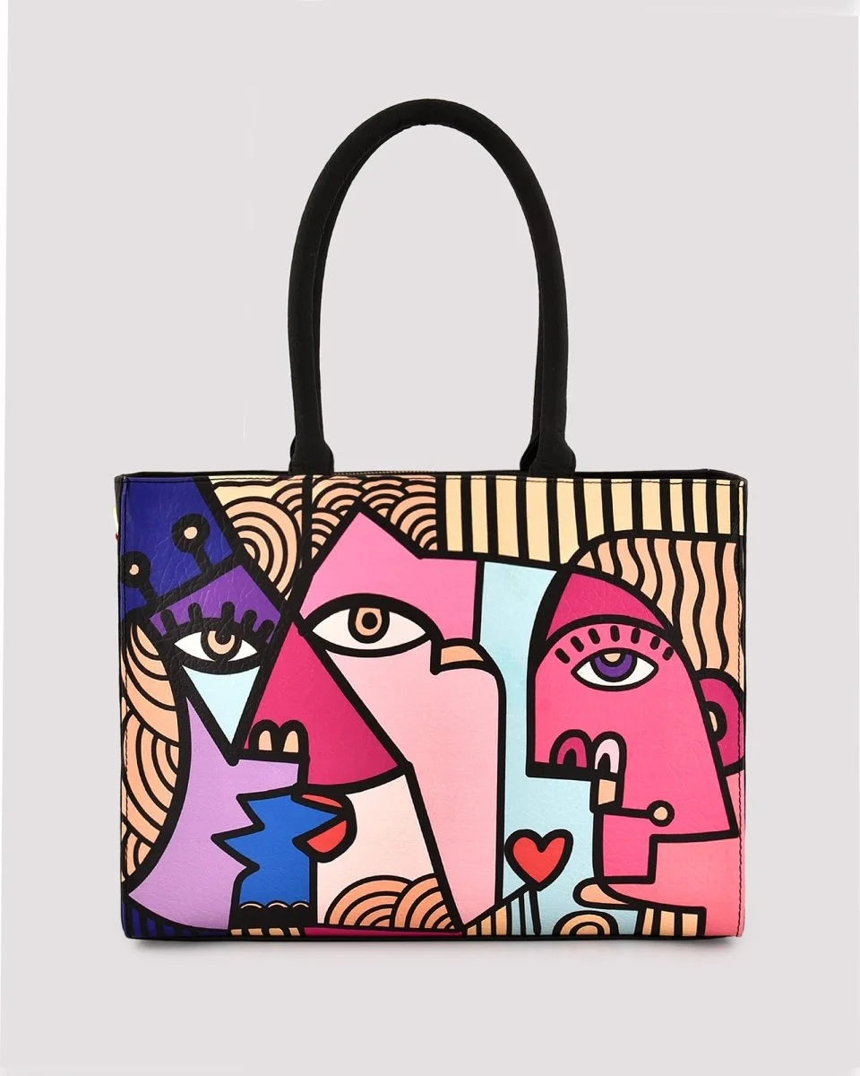 Colorful tote bag with abstract face design on a light gray background